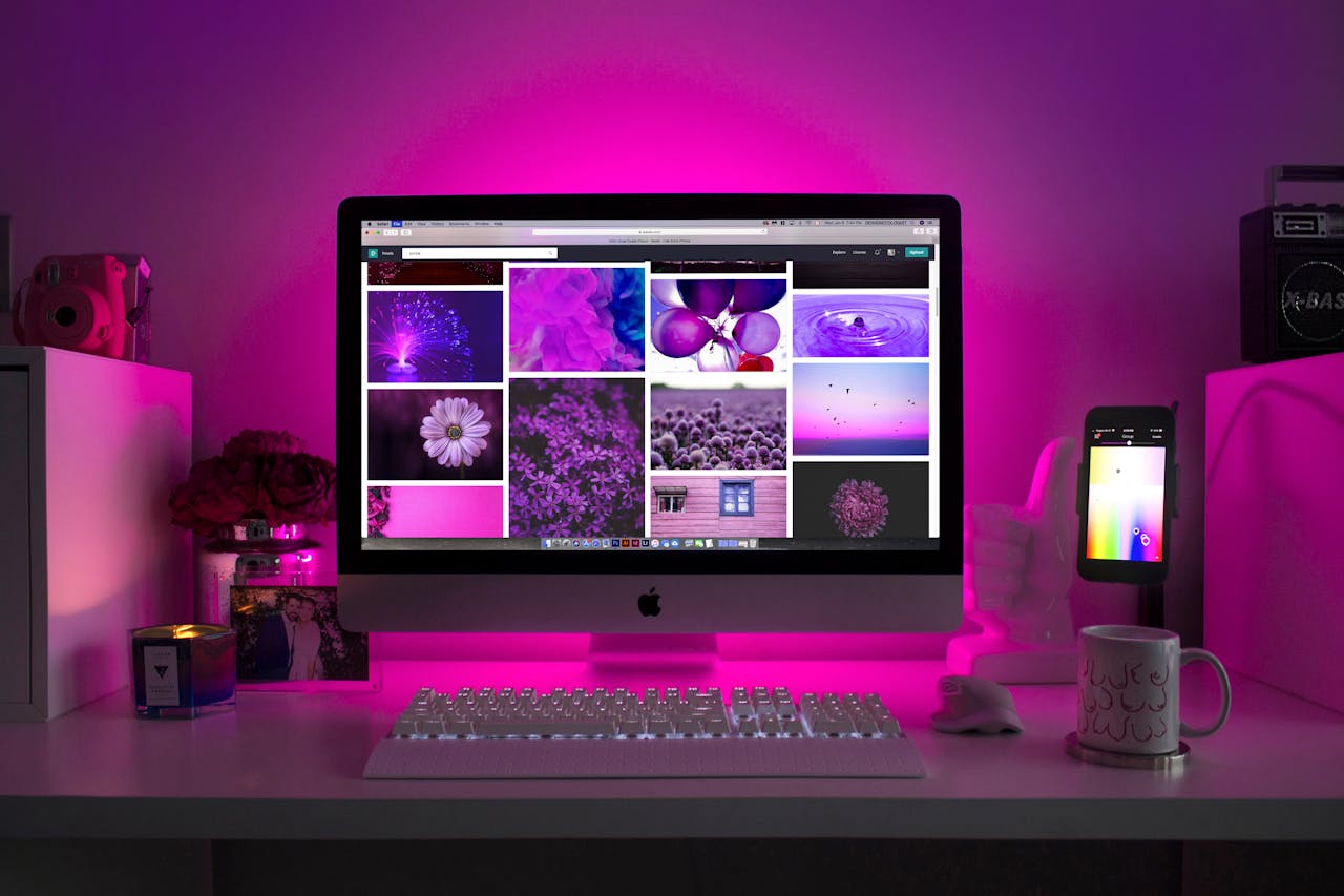 Services Modern desk setup with neon lighting and a desktop computer displaying colorful images.